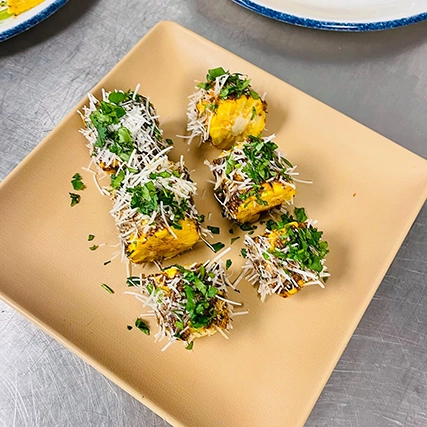 Small, colorful cubes of garnished food.